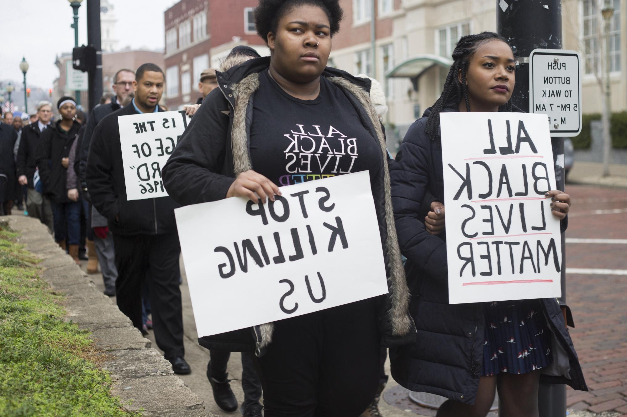 Two Black women holding BLM signs